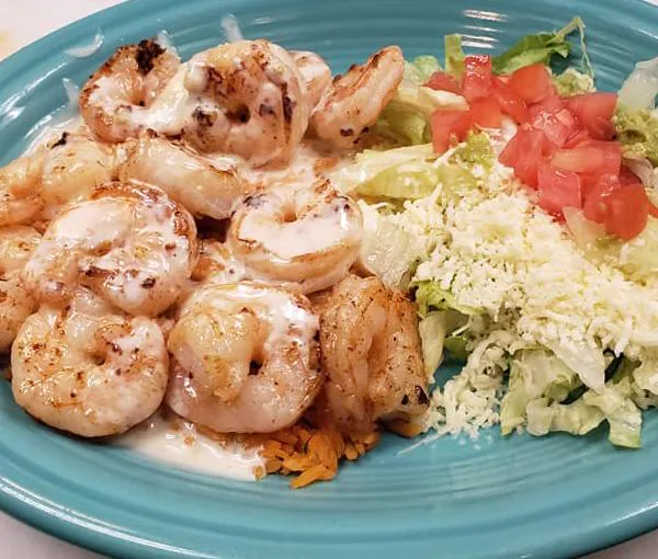 Grilled shrimp over rice with a fresh guacamole salad