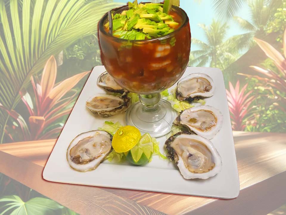 Seafood cocktail served with oysters, avocado, and lime